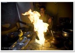 The flame shoots five feet into the air and then he pored the flaming liquid on top of my gray mountain.