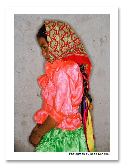 In the village of Guagüeyvo, ten-year-old Leticia Mancinas García shows off the flamboyant colors and flounces of holiday fashion.