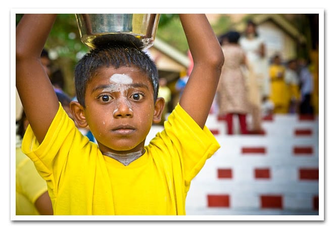 A child carring his kavadi of milk to offer to Muruga. A child carring his kavadi of milk to offer to Muruga.