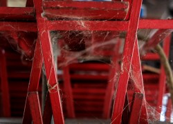 Old red benches are stacked in the Campbell Street marketplace in Georgetown Penang